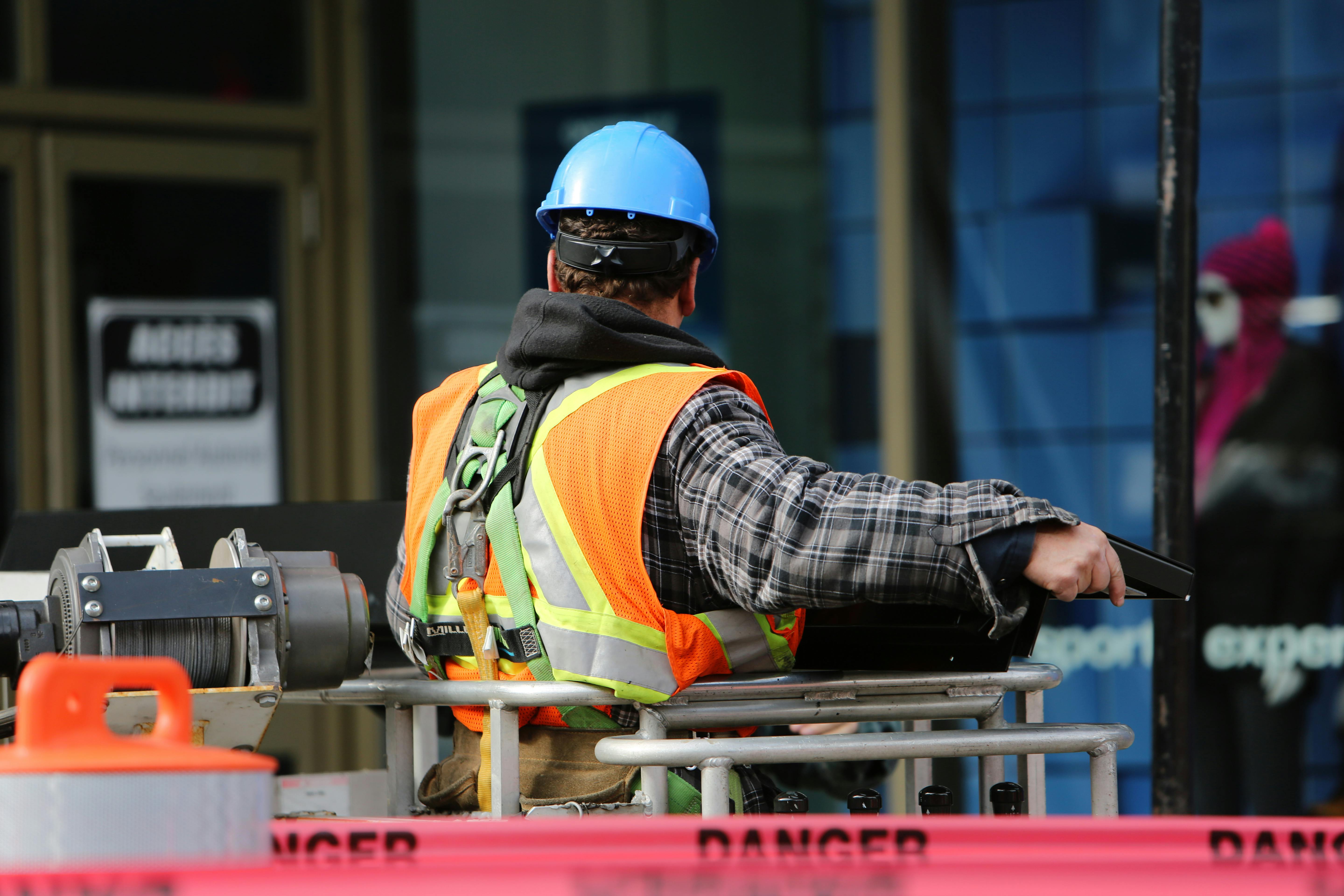 Construction worker in safety vest on lift